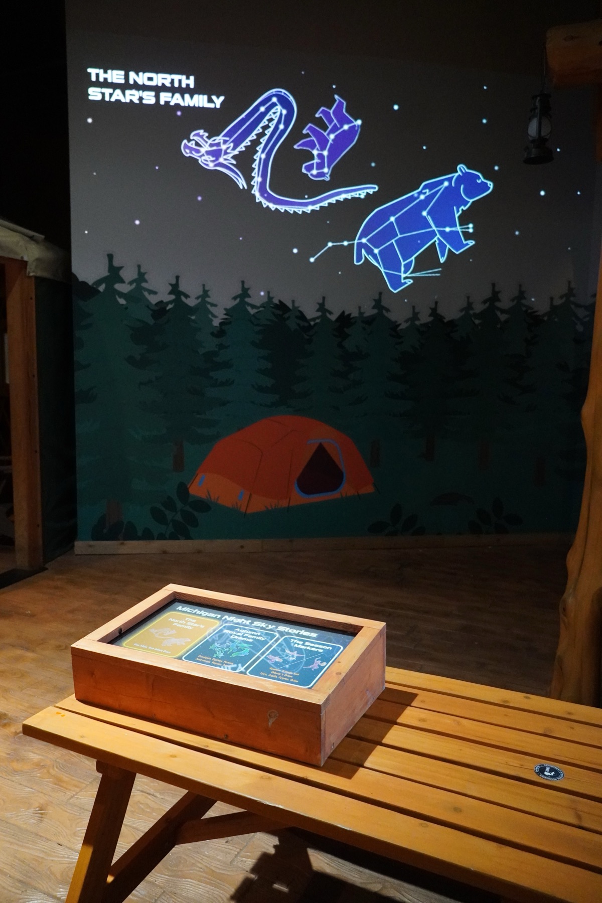 Night Sky gallery: a constellation mural above a tabletop interactive on a picnic table